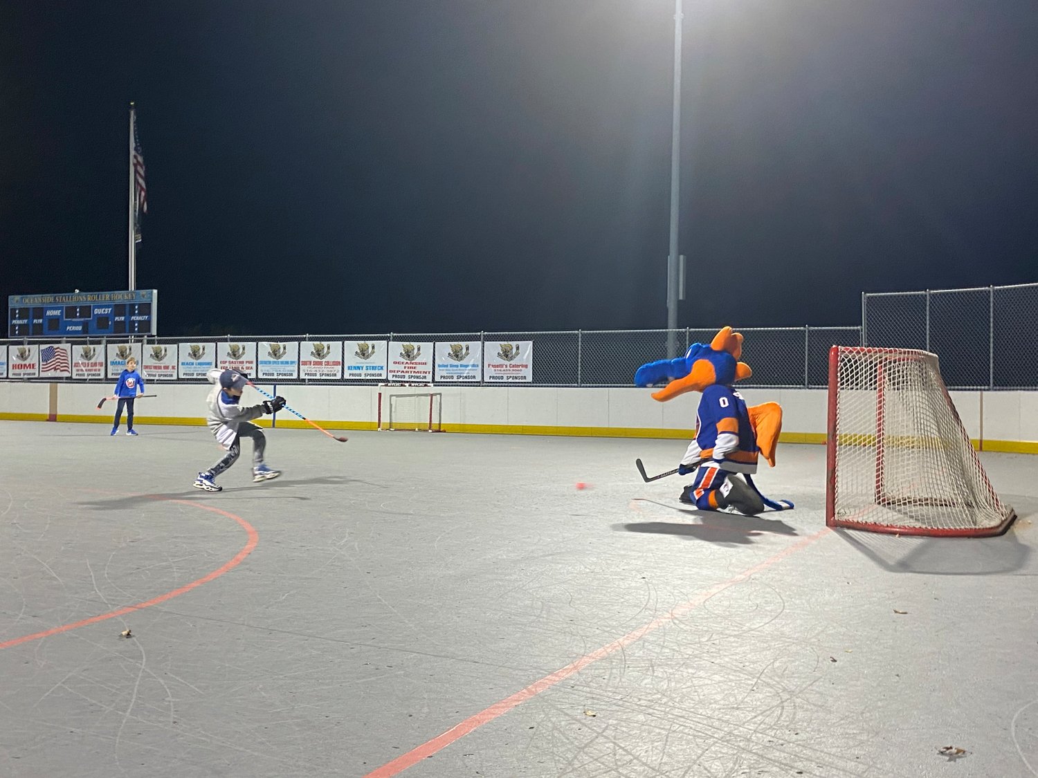 A participant of the clinics rips a shot at Sparky during a shootout challenge.