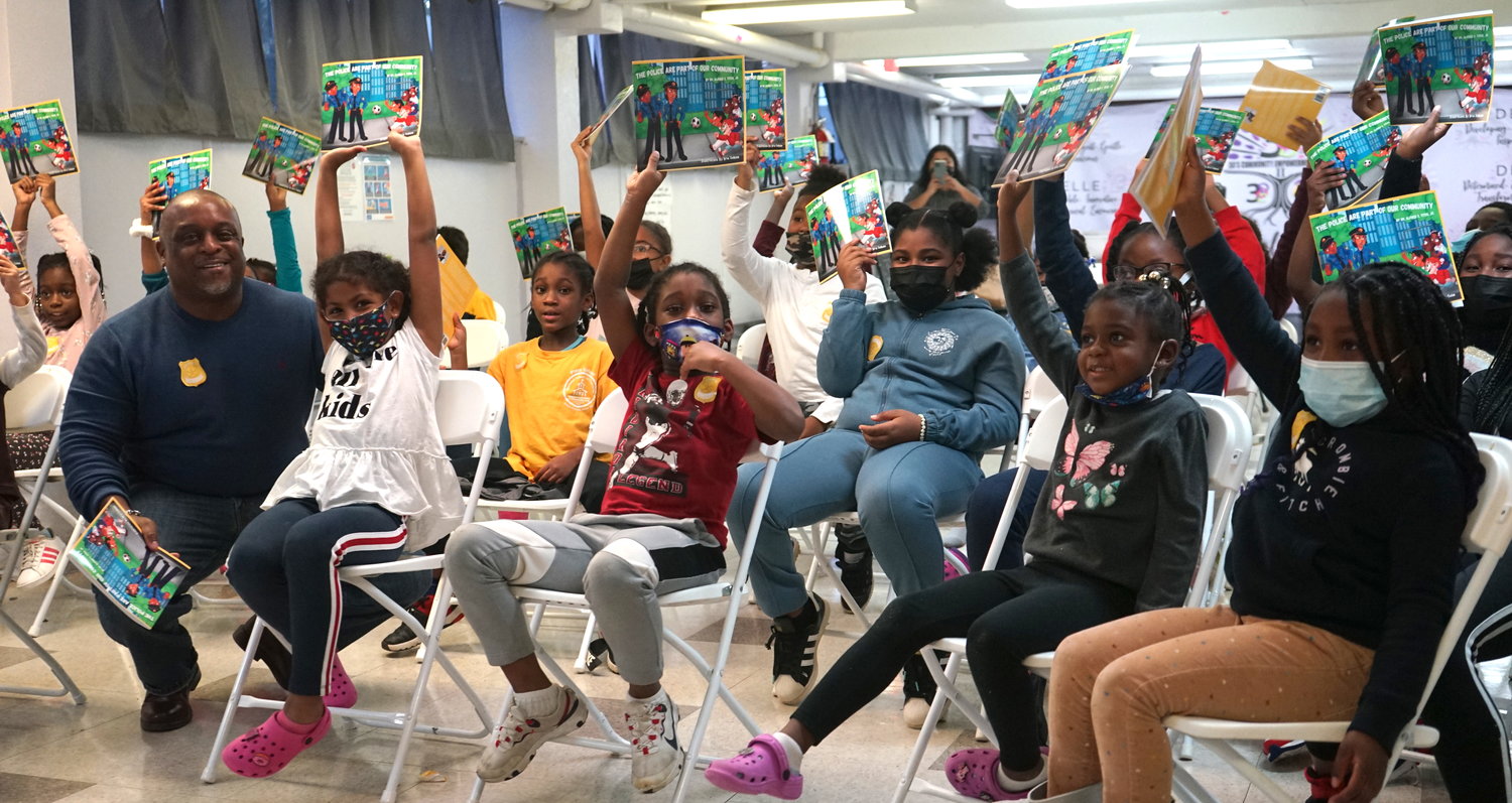 Dr. Alfred Titus, left, read his new children’s book about police to the children of the 3 D Aftercare in Baldwin, where he wanted to start the “talk” that many parents of color have with their children about the police.