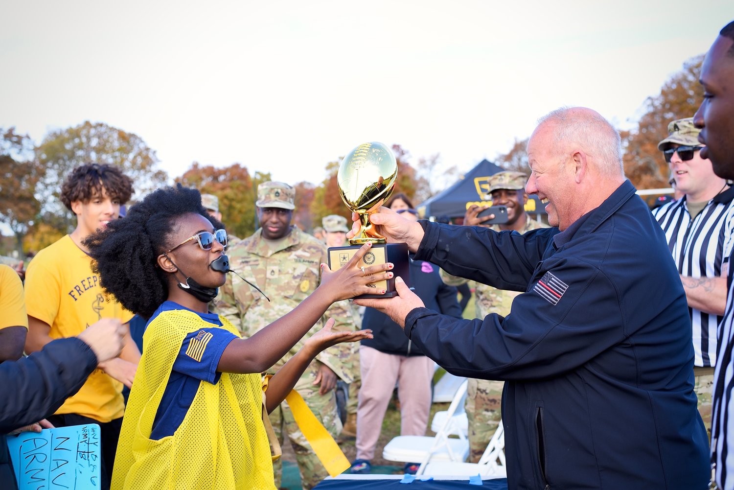 Cadet Commanding Officer Jillian Neblett received the team trophy from Mayor Kennedy.