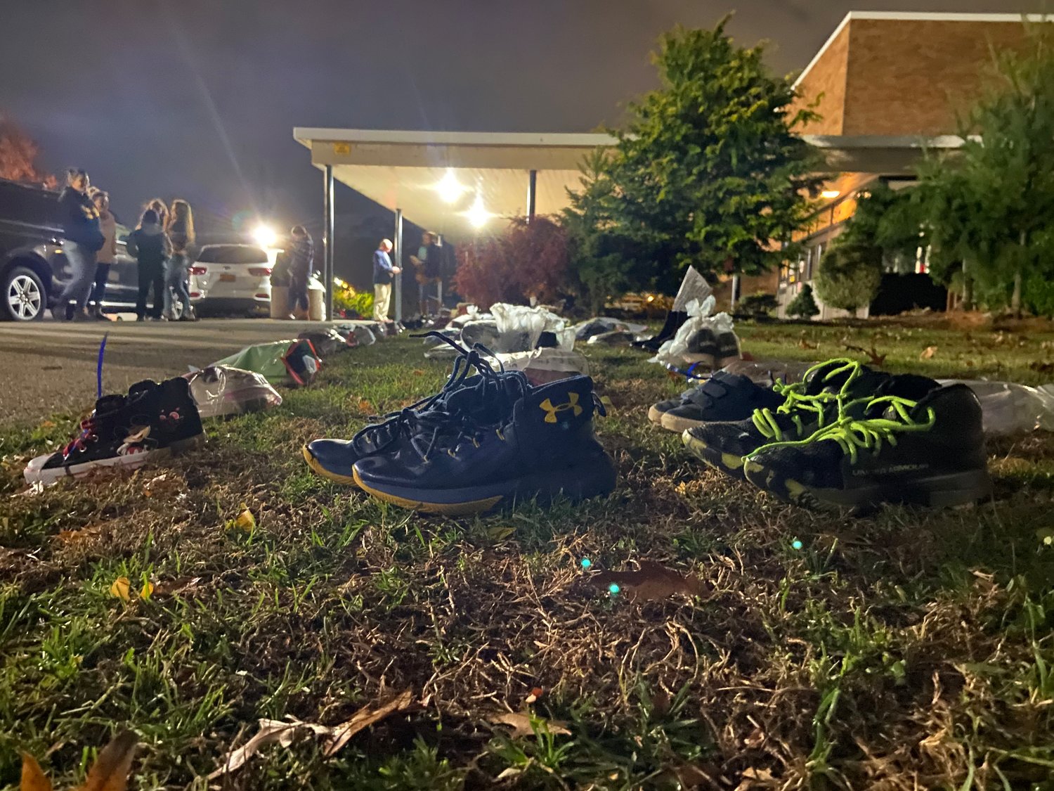 Shoes were lined up outside Wantagh High School on Nov. 18, part of a statewide movement called Operation Shoe Drop. The Wantagh drop-off took place prior to a Board of Education meeting.