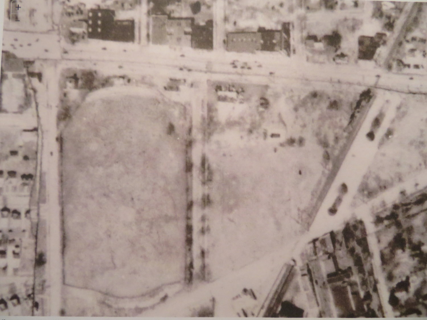 The property existed as a field, with the LIRR running diagonally in its eastern corner, in 1926.