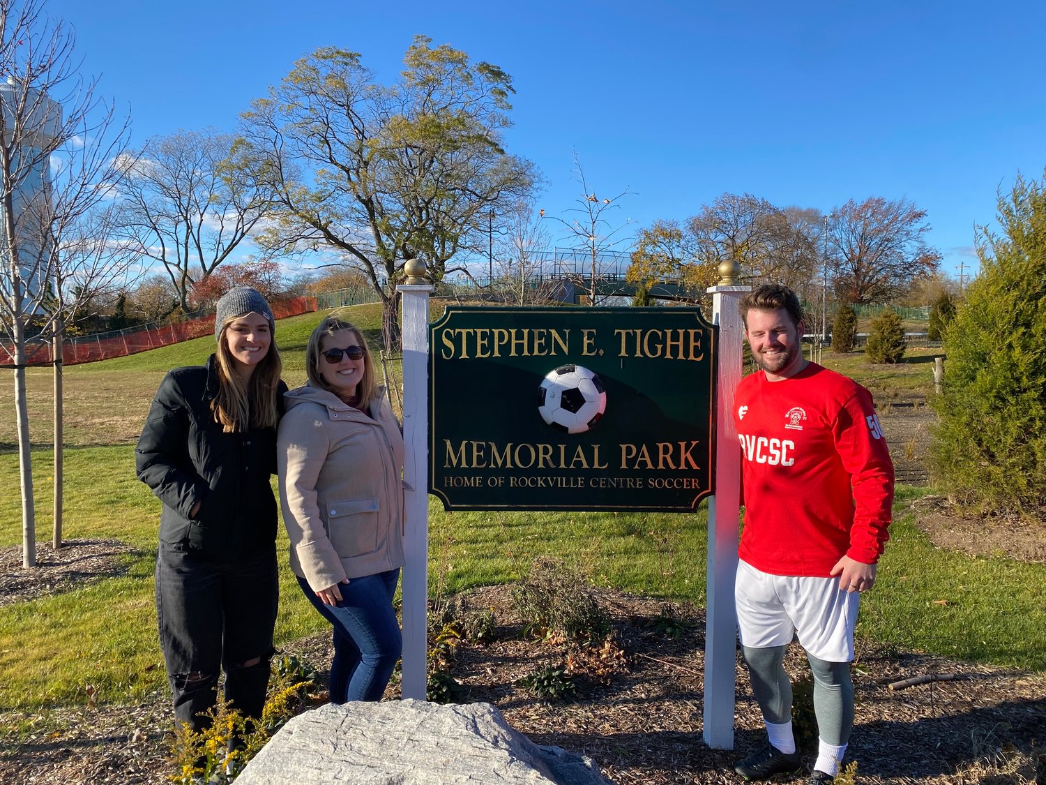 Tighe’s daughters, Lindsay, far left, and Elizabeth, and his son, Patrick, celebrated his memory at the new artificial-turf field on Windsor Avenue.