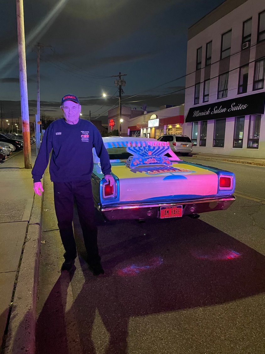 Alan Stewart, a vintage car owner from Merrick, donates one of his vehicles every year to the parade. This year his 1969 Plymouth Roadrunner sported a menorah for the festivities.