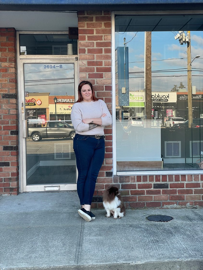 Owner Shelby Grillo outside of her store with her dog, Capone.