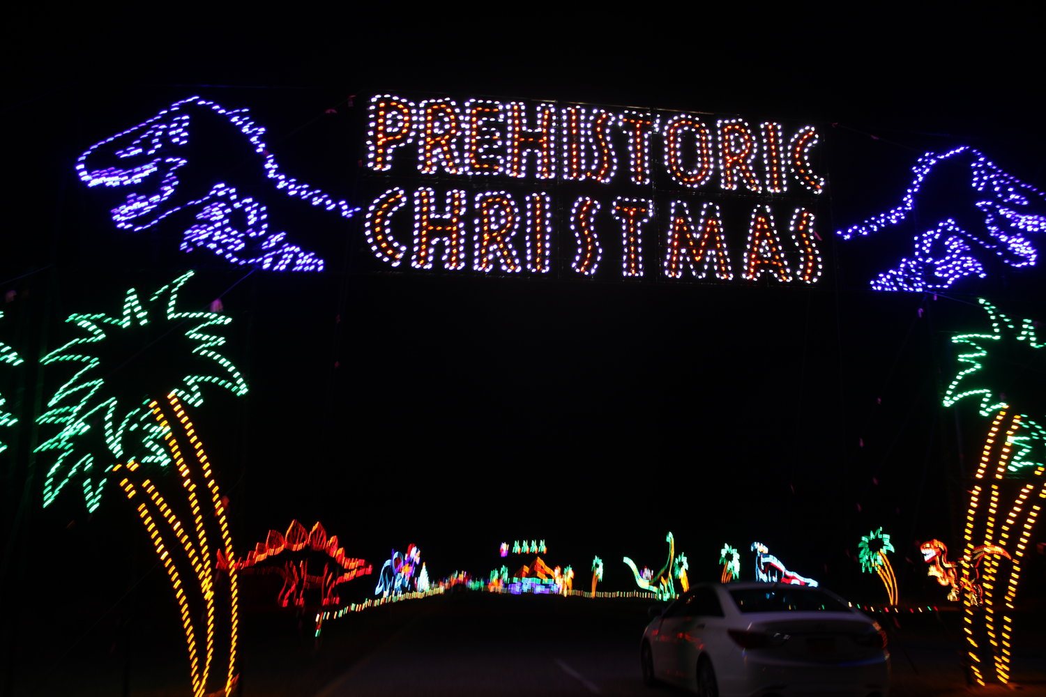 A prehistoric era section in the Magic of Lights holiday display at Jones Beach State Park features dinosaurs decorating for the holidays.