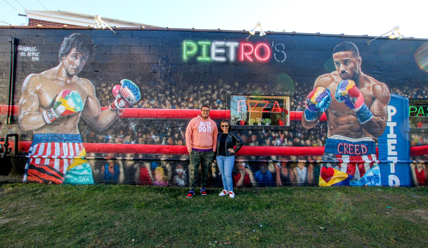Andaluz the Artist, left and Lauren stand in front on the mural that was finished on Nov. 21, the 45th anniversary of the movie “Rocky.”