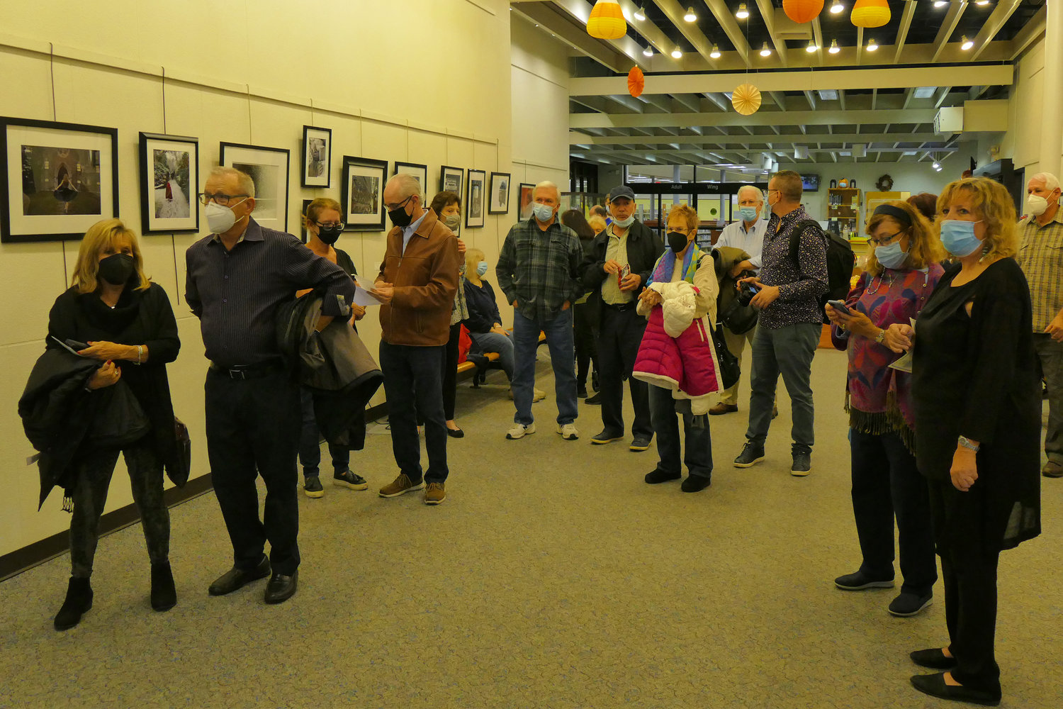 Visitors to the awards ceremony for the photography show discussed the winning photos before the ceremony began.