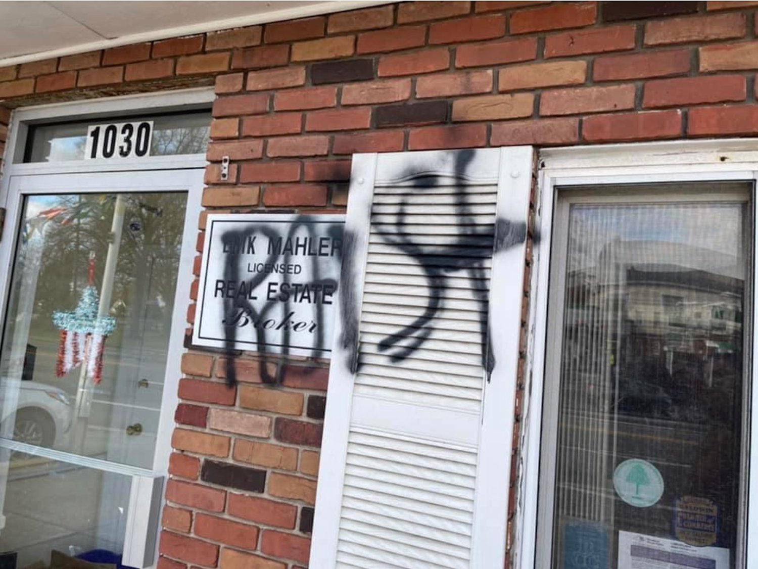 The word “Raist” — a misspelling of “racist” — was graffitied on the front entrance of Mahler Realty on Merrick Road in the early hours of Nov. 27.