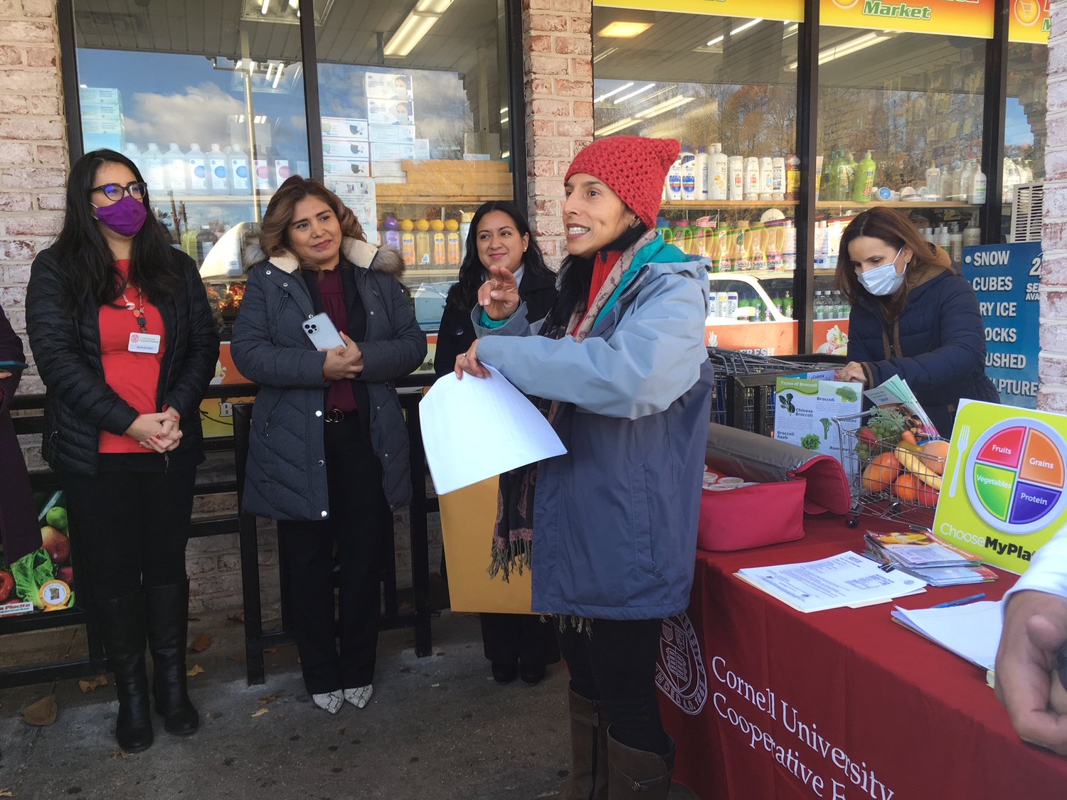 Vanessa Lockel, executive director of Cornell Cooperative Extension of Suffolk County, explained the program outside of La Placita Supermarket on Friday.
