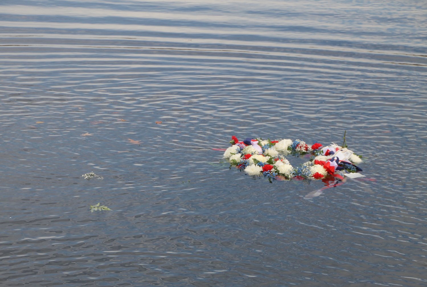 The Pearl Harbor memorial wreath floated in Mill River.