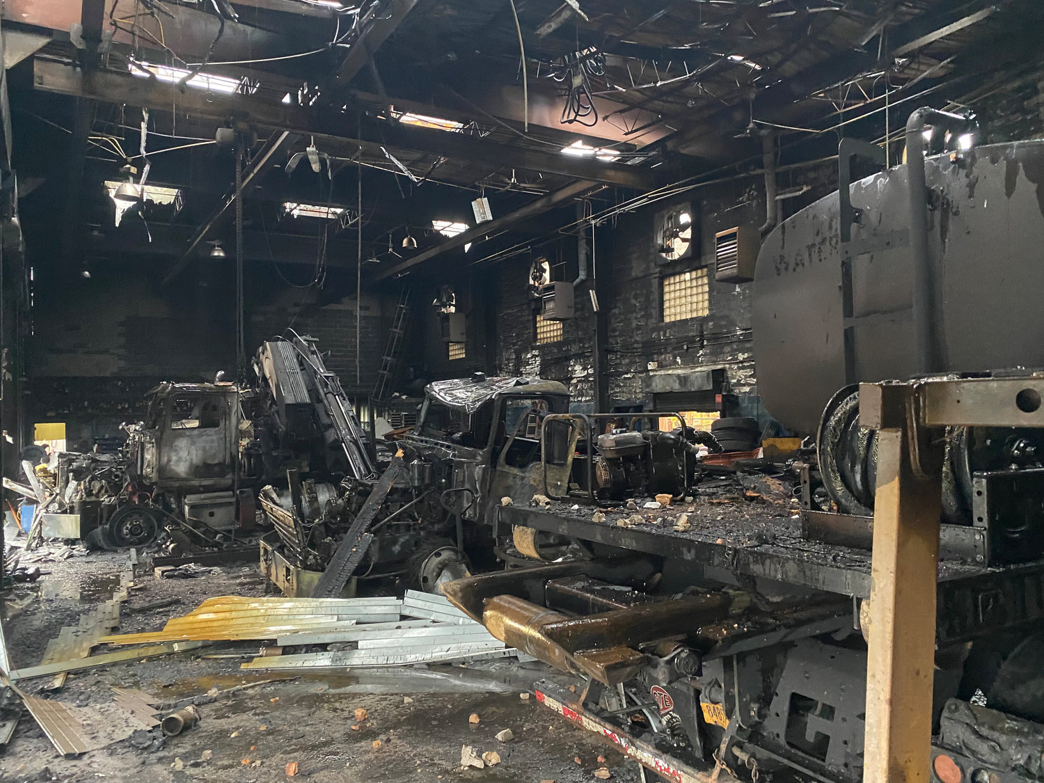 Four New York Boom Trucks vehicles were damaged in the Dec.18 building fire at the Inwood-based business.