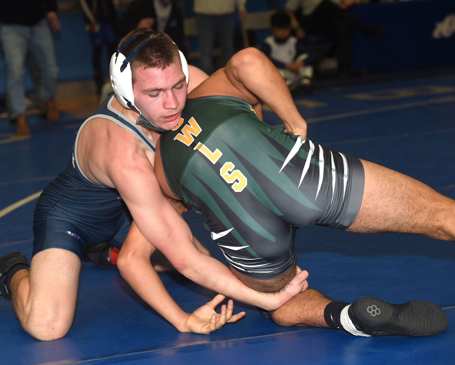 Oceanside's Hugh Bittenbender, left, had a solid showing in the Long Beach Tournament at 138 pounds to open the campaign.