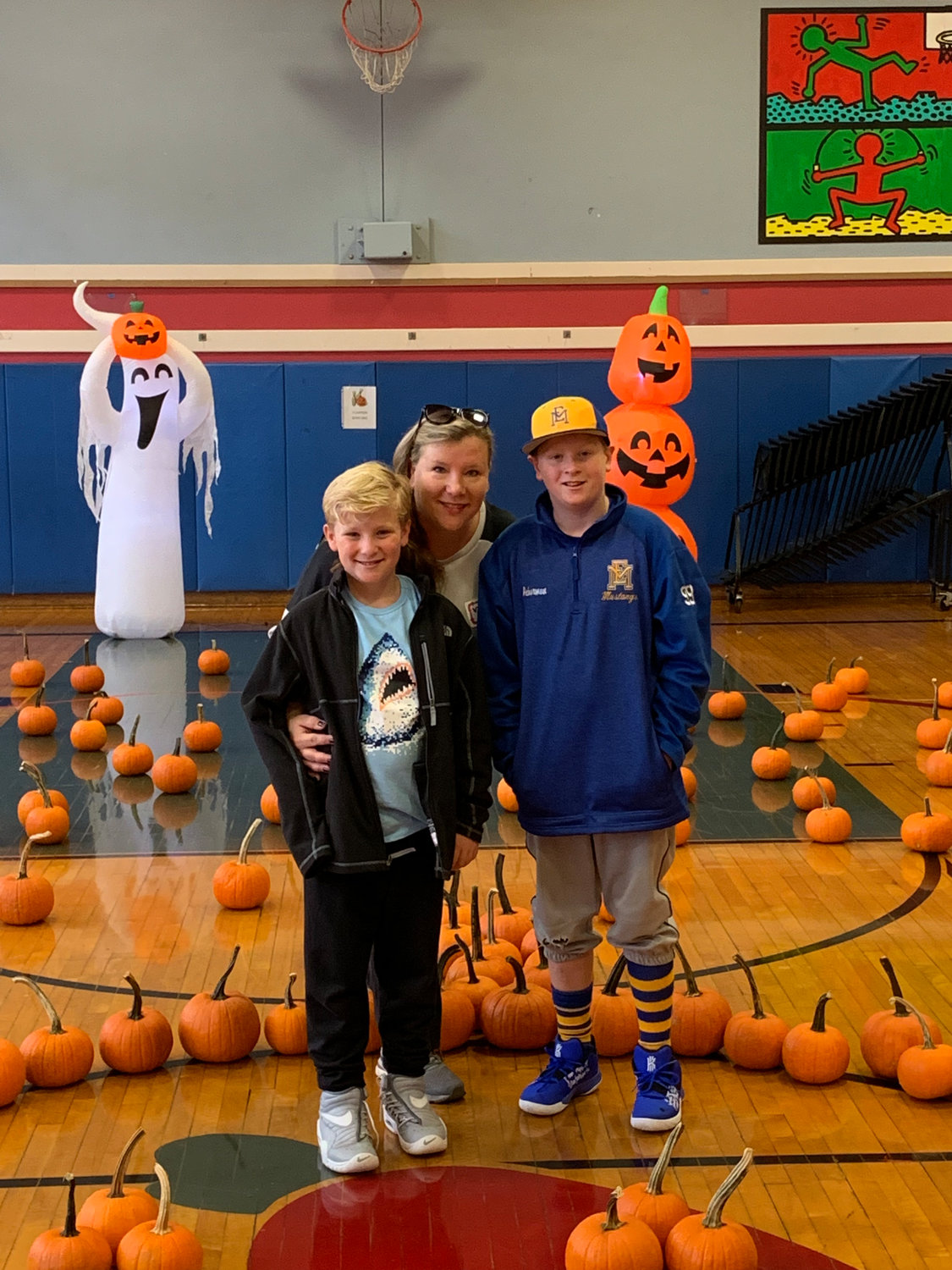 Jennette Ackerman, president of the Barnum Woods PTA, with her sons, Bennett, left, and Connor in 2020 at the PTA-sponsored Pumpkin Patch, focuses on giving children fun school experiences.