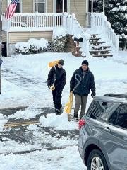 Lucas Brown, left, and his father, Brian, helped shovel out their neighbor's house.