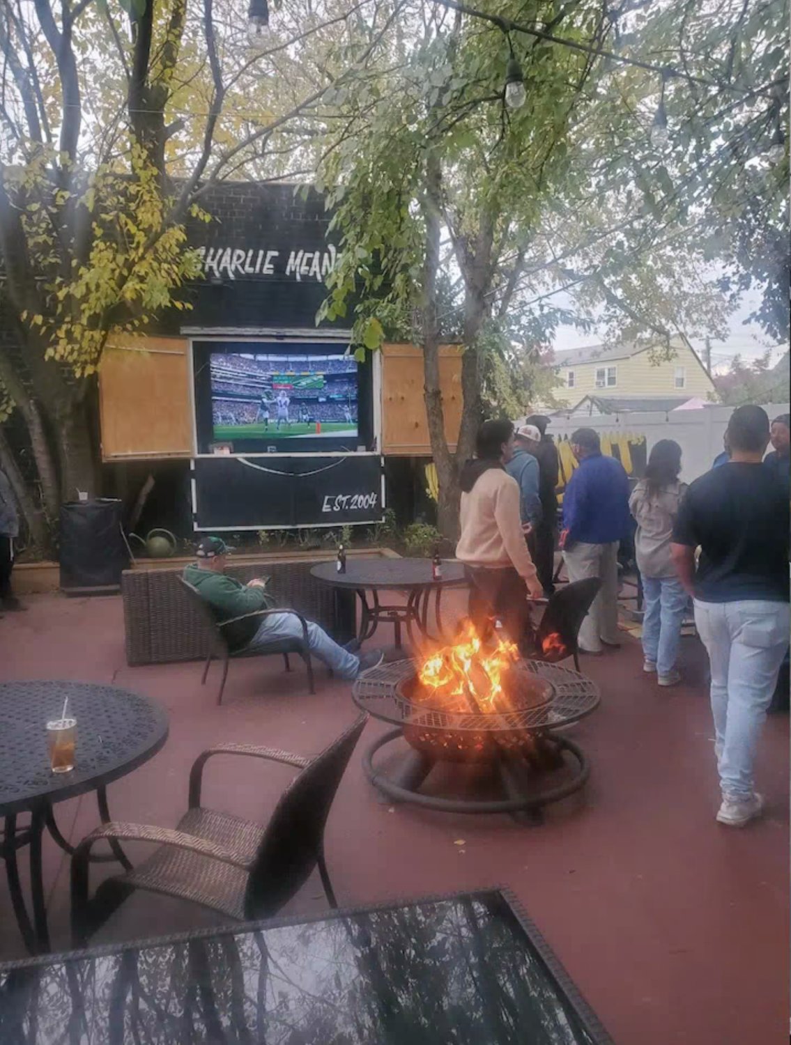 Customers gathered to watch football in the backyard of Charlie Meaney’s.