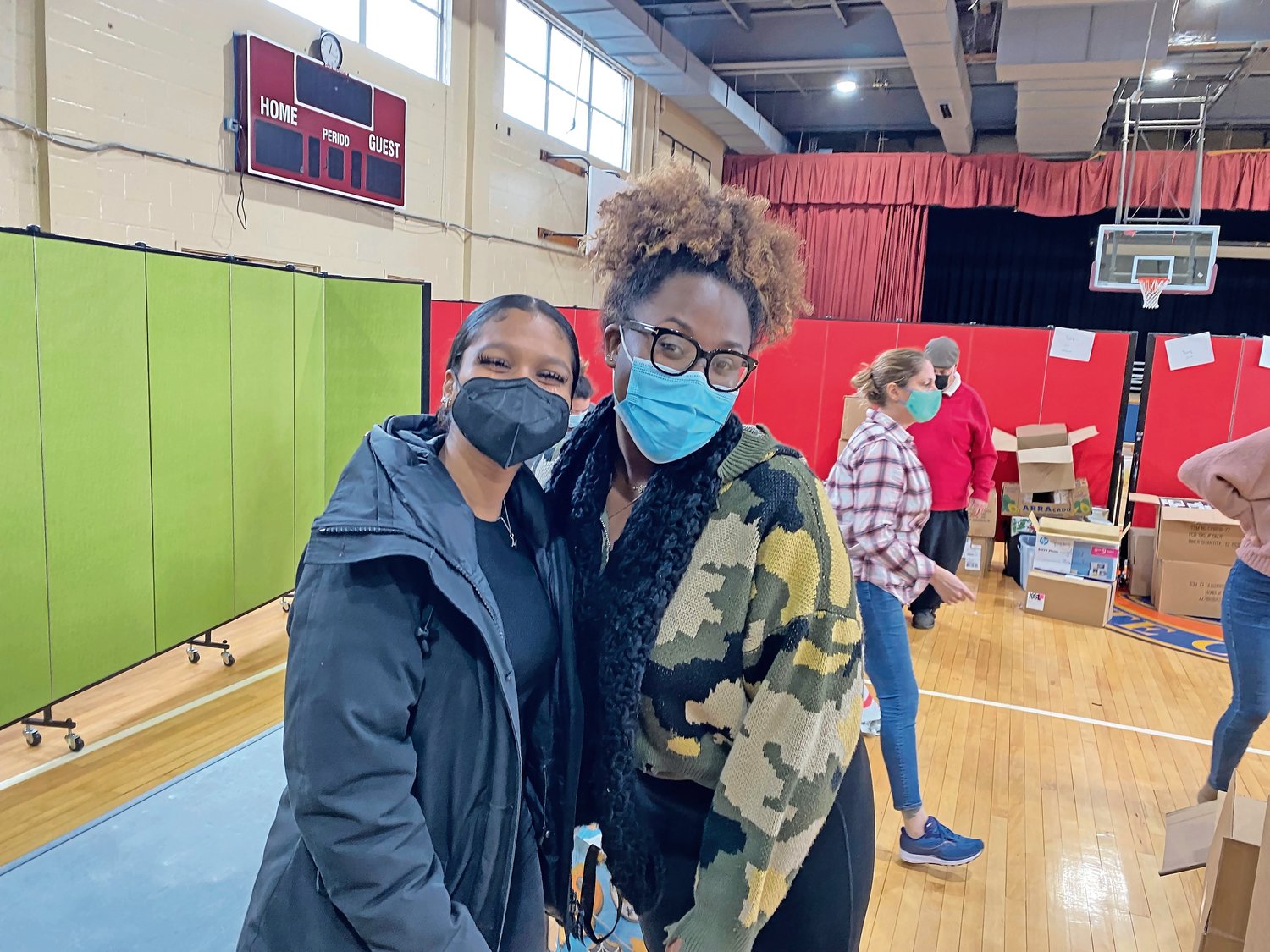 Rock and Wrap It Up volunteers Mylana O’Reggio and Taylour Peters at the Five Towns Community Center on Dec. 24.