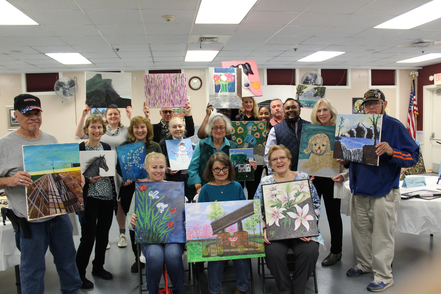 Matt Khan with his students at the Community Center showing off their completed works at the end of the 2021 acrylic art class.