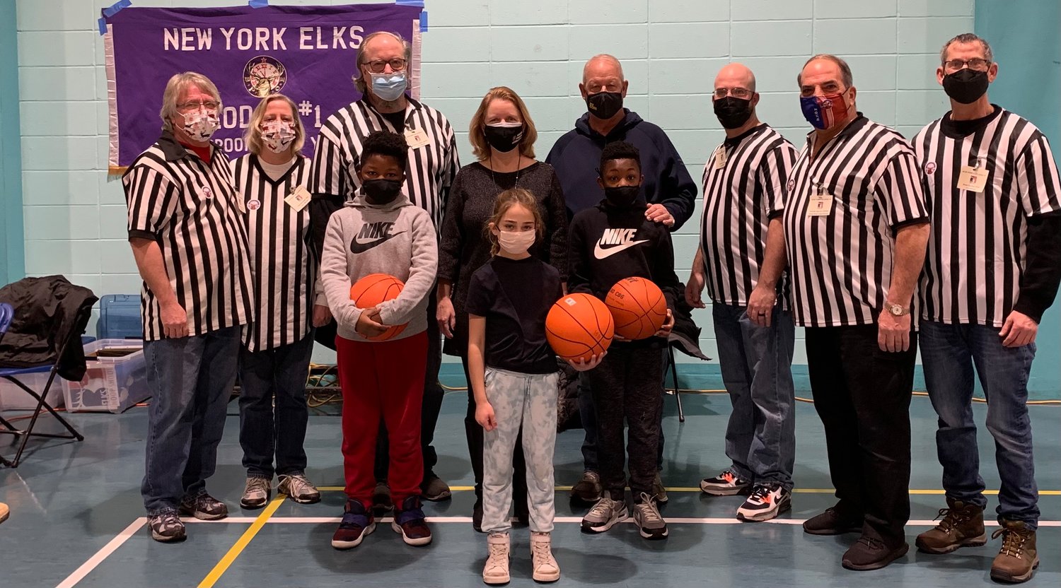John Nuzzi Sr., second from right, headed up this year’s lodge-level Hoop Shoot, supported by Freeport Mayor Robert T. Kennedy, fourth from right, Legis. Debra Mulé, fifth from right, and members of New York Elks Lodge #1. Four children qualified for the district competition on Jan. 22.