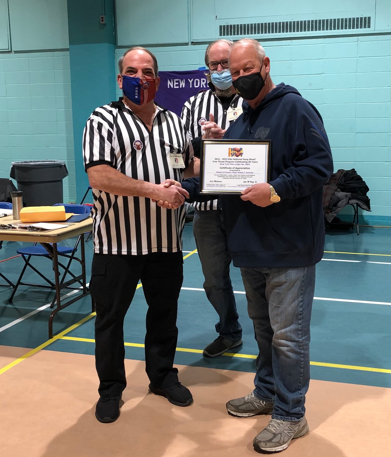 John Nuzzi Sr., left, presented Mayor Robert T. Kennedy, right, with a certificate of recognition to thank the Village of Freeport for its support of the Hoop Shoot.