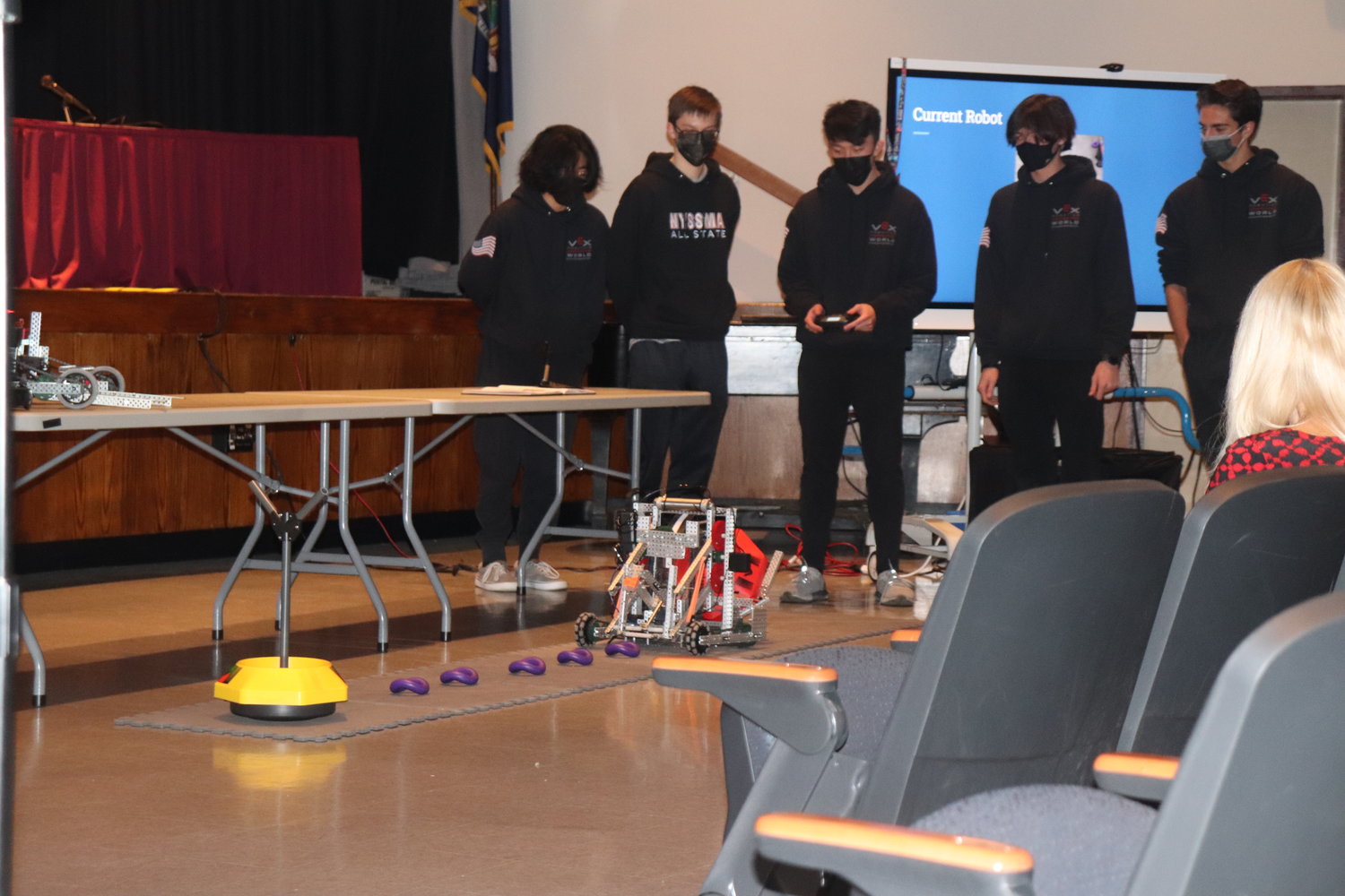 During the meeting, the VEX high school robotics team demonstrated their robot that picks up “ringles,” or rings that look like Pringles.