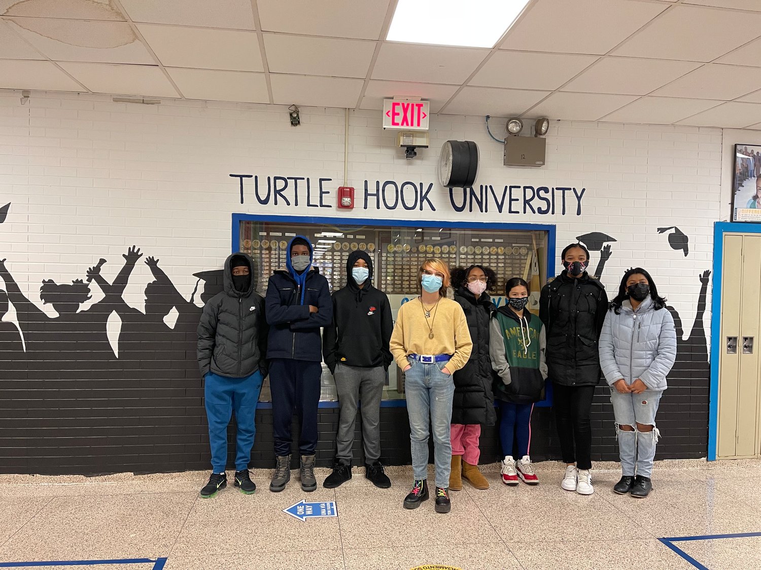 The Turtle Hook mural crew and their teacher celebrated the completion of their project.