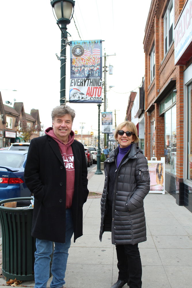Mike Stanko and Karen Zang underneath one of the light posts with Stanko’s work, which they both enjoy seeing on the street while shopping locally.