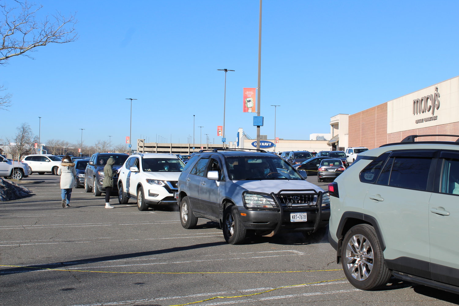 Lines of cars waited outside the Macy’s Men’s Store parking lot for their kits.