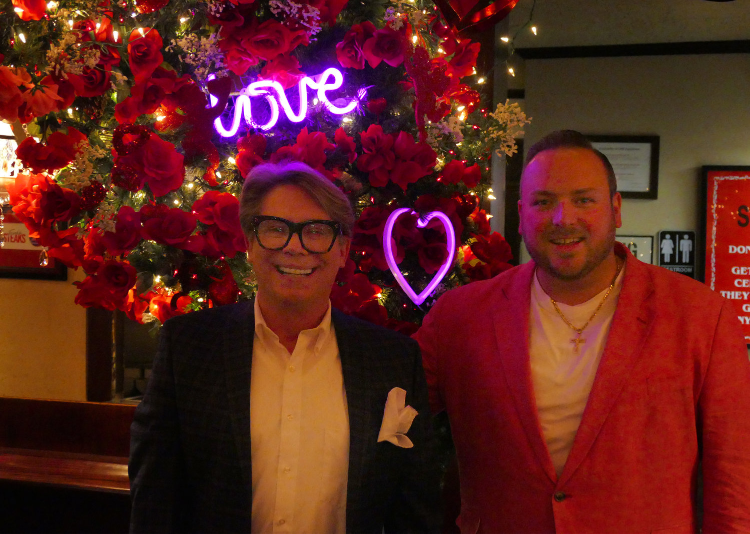 Interior designer Michael Delahanty (left) and Frank's Steaks owner Chris Meyer in front of the "lovers' lane" portion of the Valentine's Day design installations.