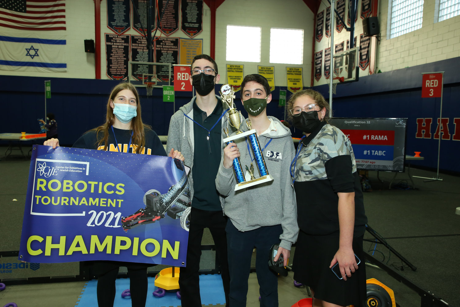 The Hebrew Academy of the Five Towns and Rockaway High School robotics team captured its first-ever first place trophy at the Center for Initiatives in Jewish Education Robotics Tournament on Dec. 16 at HAFTR. From left were Shirly Gottlieb, the Robotics Club president, and team members Sean Harris, Yoni Goldstein and Atara Smulevitz.