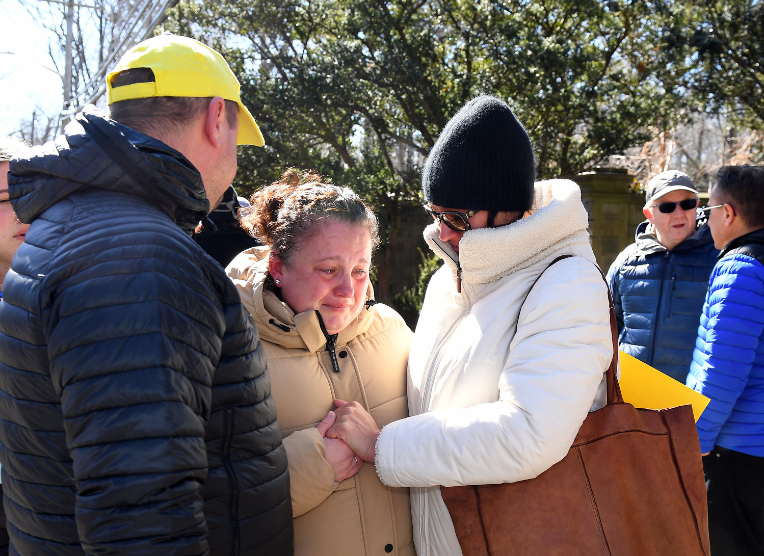 Outside of the gates of Killenworth mansion in Glen Cove,  protesters consoled a woman crying after the news conference to condemn and expel Russian diplomats from the compound.