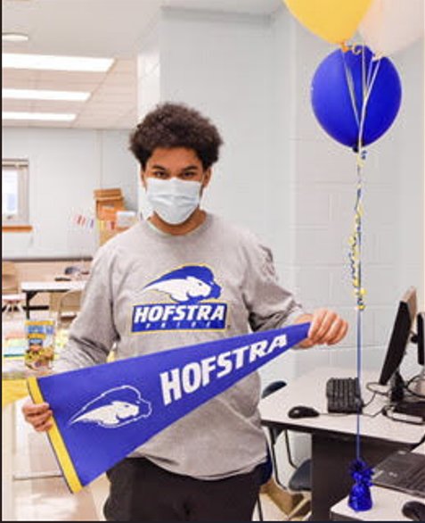 Javier Berrios received a Hofstra University sweatshirt and banner at his surprise acceptance party.