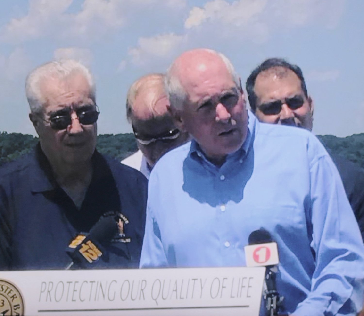 John Taylor, center, held a press conference at Theodore Roosevelt Memorial Park and Beach in 2018. He was there in his capacity as the chair and co-founder of Coalition Against an UnSound Crossing to fight Gov. Cuomo’s plan for a tunnel on the North Shore. Larry Schmidlapp, mayor of Centre Island and Town of Oyster Bay Supervisor Joseph Saladino were there to show their support.