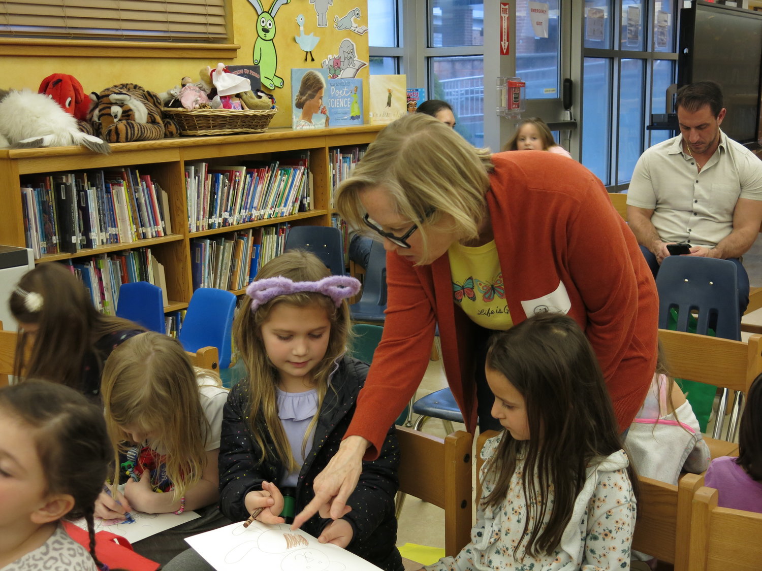 Author and illustrator Kathleen Bart gave Roosevelt Elementary first-grader Kylie Joannon, left, a suggestion on how to draw a teddy bear, which Savanna Silvio listened to as well.