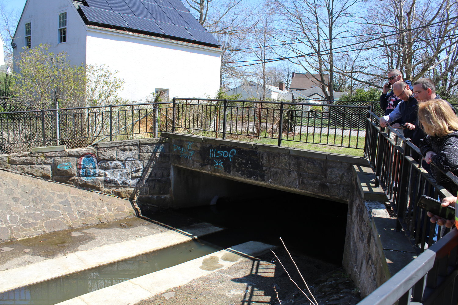 Community members inspected the fish scaffold, in which the passage was deepened from two to four inches.