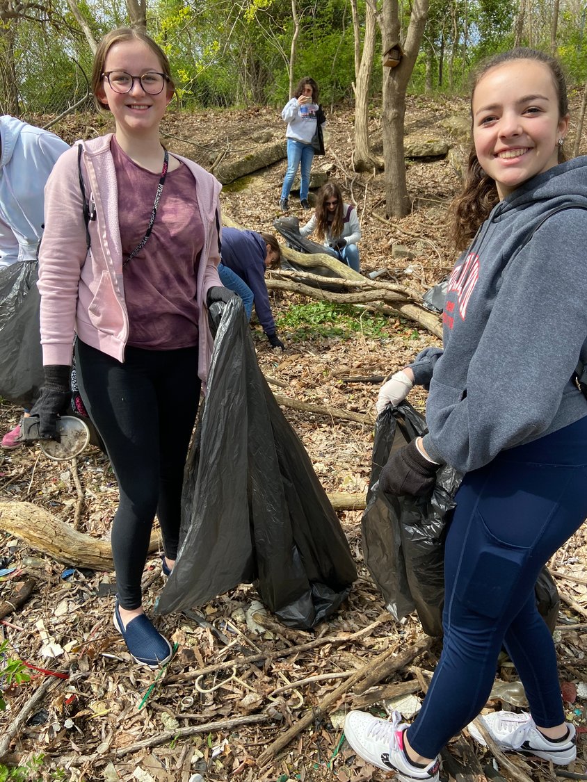 Annabella Petillo, left, and Gabby Palmer, both 14 and students at W.T. Clarke High School, filled their trash bags at the cleanup.