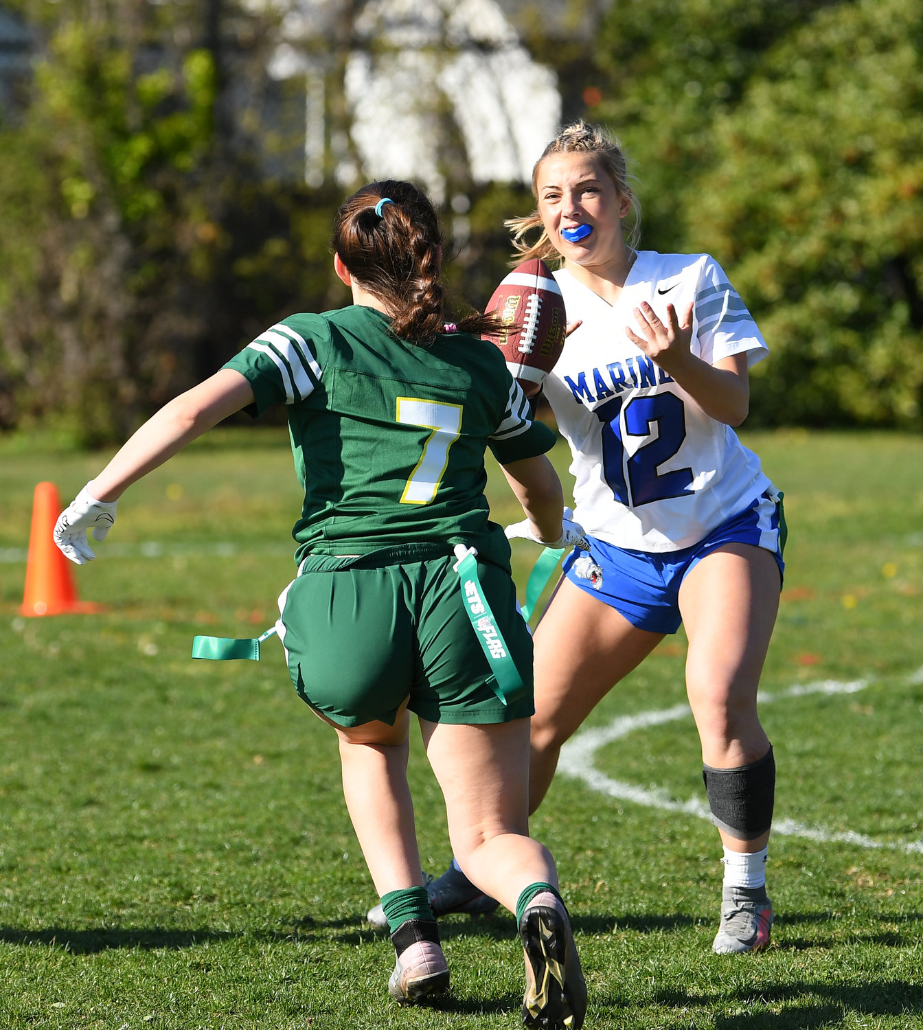 Long Beach’s Rylee Roberts, right, took a handoff with Lynbrook’s Izzy Sanchez in pursuit during the April 28 matchup.