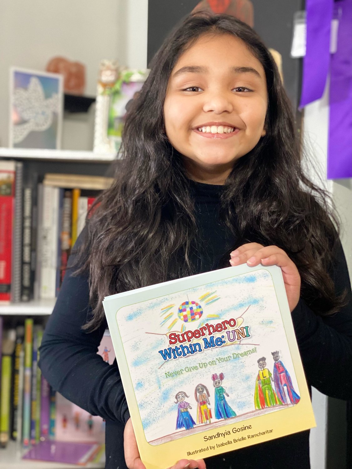 Isabella Brielle Ramcharitar became a mini-celebrity at Steele Elementary School when she was able to read her book to her class, also achieving their “book of the month.”