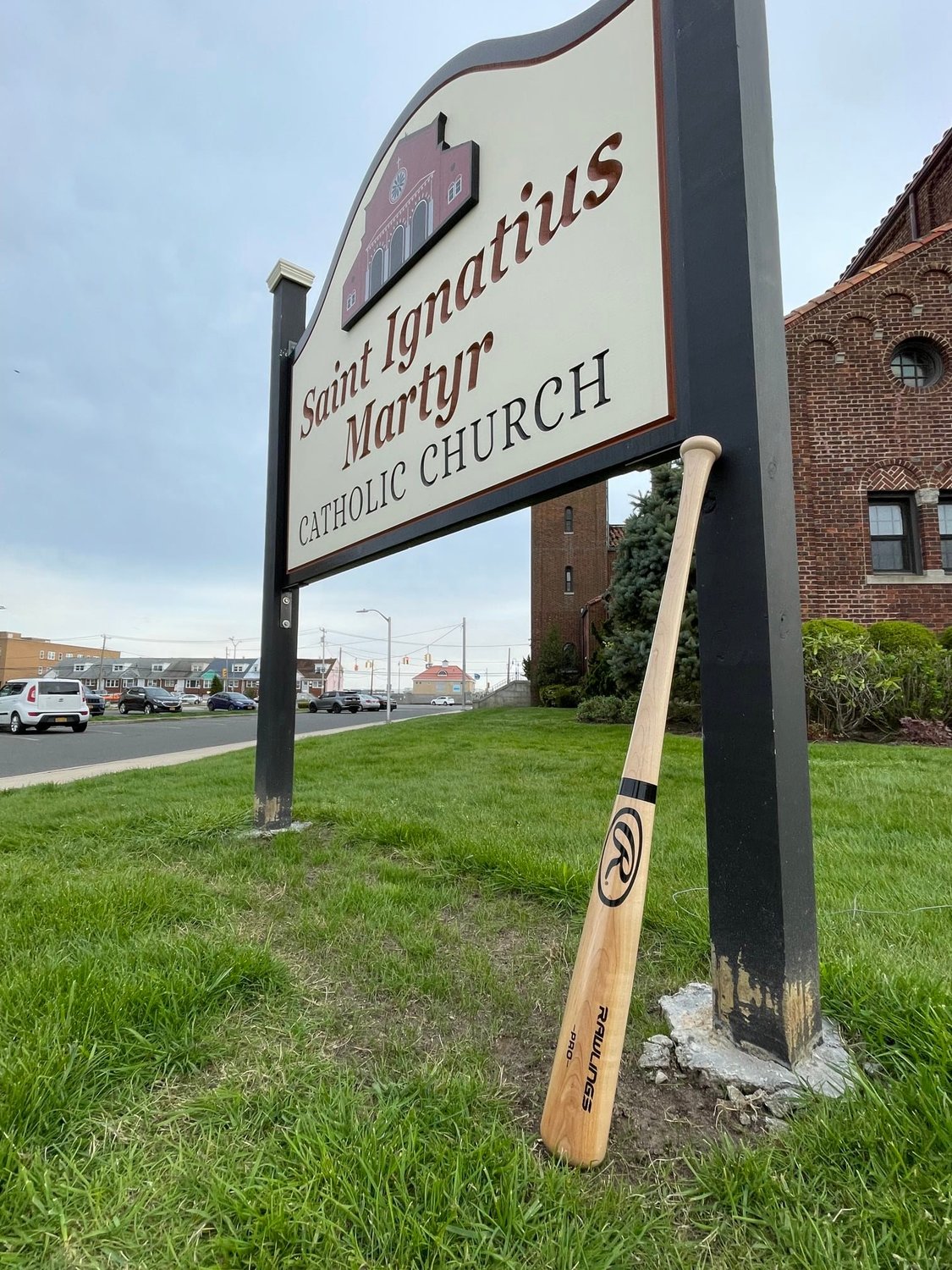 A baseball bat outside St. Ignatius Martyr Church honored 10-year-old Lazar LaPenna, who collapsed and died during a Little League game.