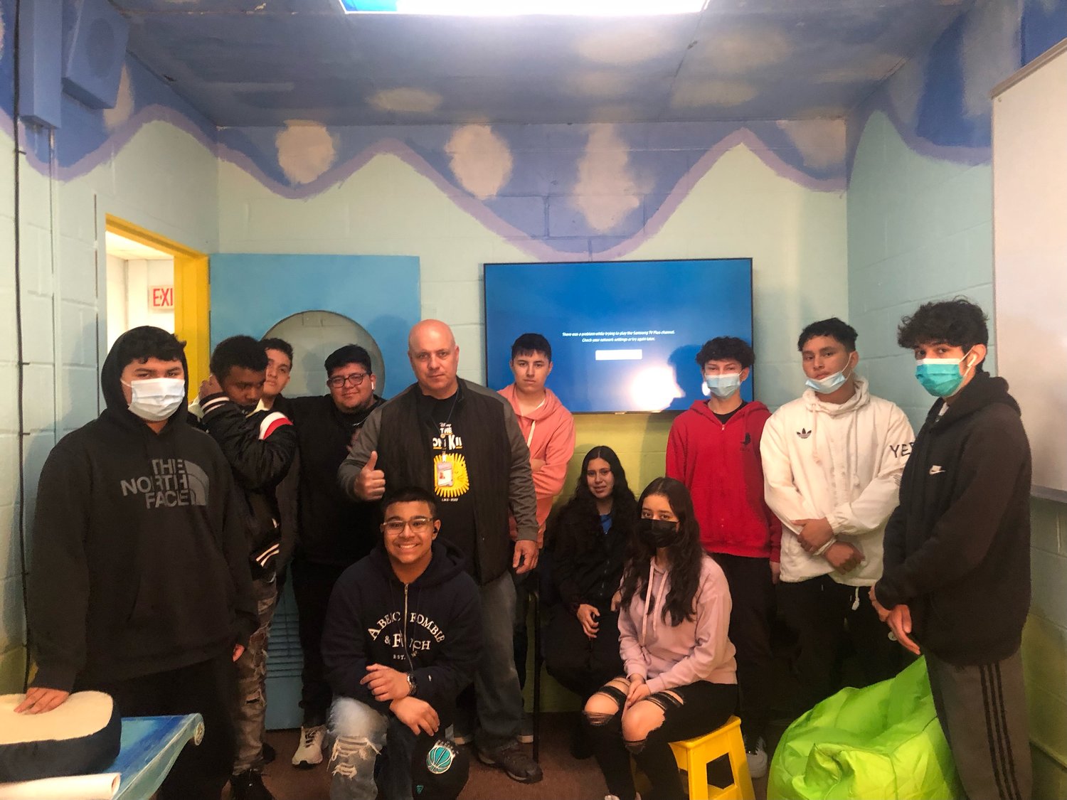 Lawrence High School’s first-period studio art class, which did the Wellness Room prep work, with art teacher Robert Verone in the finished room.