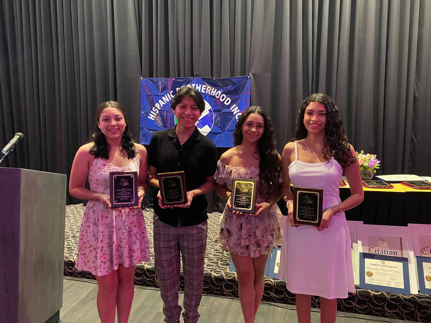 Catherine Suriel, Carlos Garcia Jr., Amanda Delahaye and Natalia Velasquez (left to right) were awarded scholarships by the Hispanic Brotherhood last Thursday.