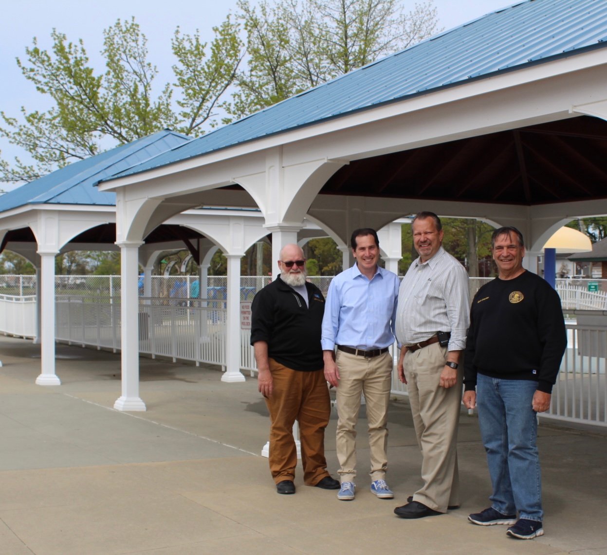 Kaminsky secured a $50,000 grant for a pavilion at the Hendrickson Park pool complex. Senator Todd Kaminsky, center left, poses with Mayor Edwin Fare, immediate right, in front of the new pavilion with Department of Recreation staff.