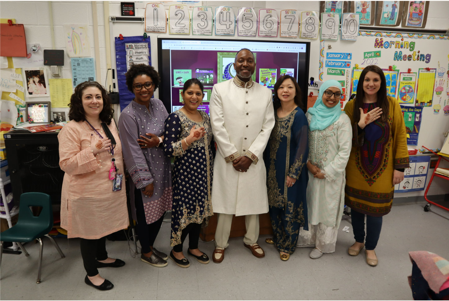 Teachers and staff at Clear Stream Avenue Elementary School dressed in traditional Islamic clothing for Eid al-Fitr.