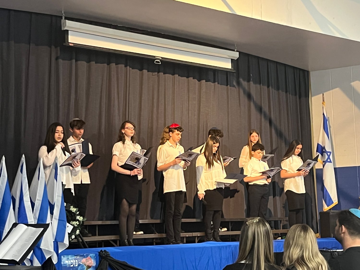 Seventh-graders at The Brandeis School in Lawrence each read a letter — written by a fallen Israeli soldier to their family during wartime —  as part of its Yom HaZikaron ceremony.