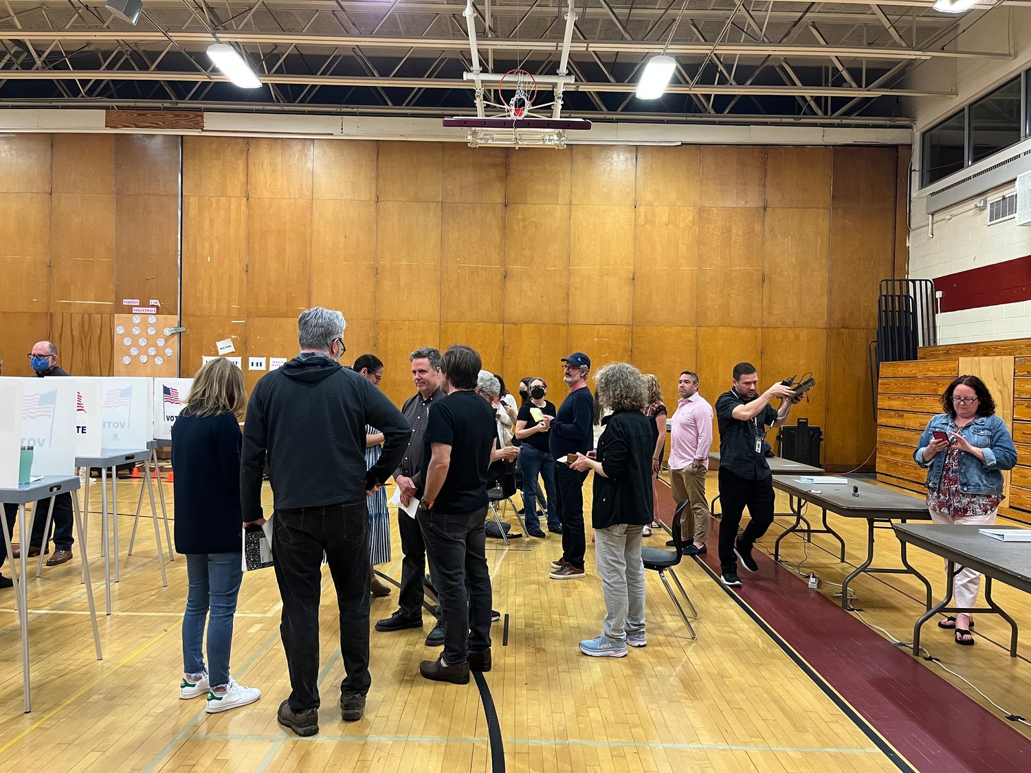 Anxious voters in the North Shore High School gym waited until nearly midnight to hear the election results for board candidates and the budget.