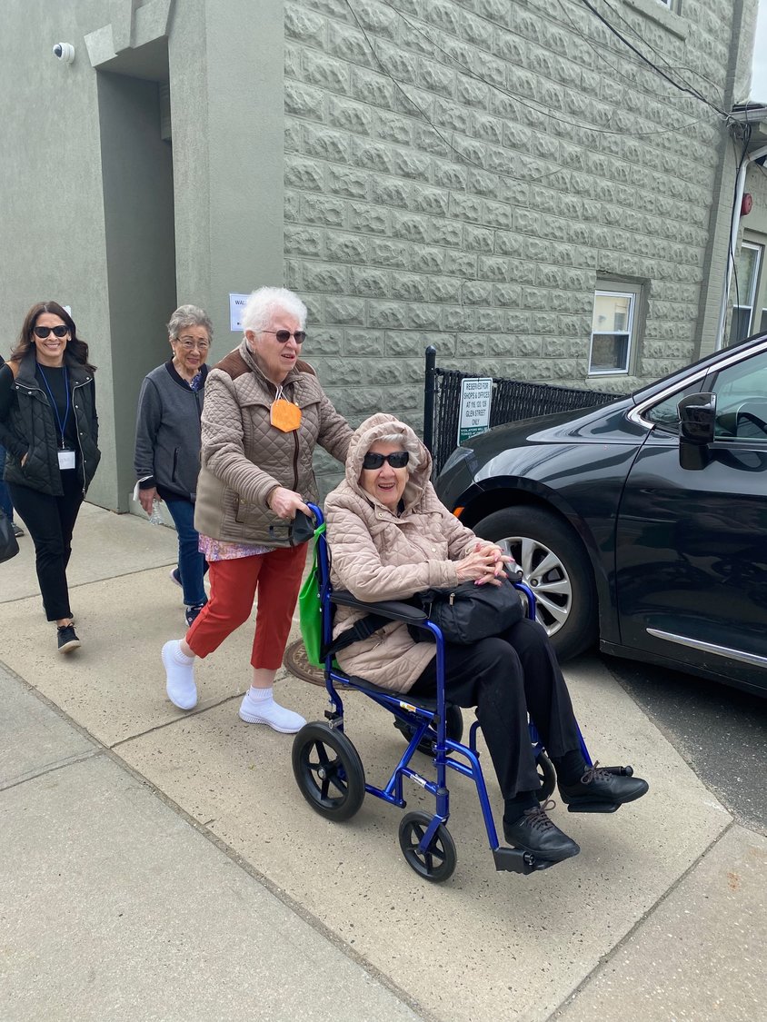 Sally Dimiceoi pushed her longtime friend Mimi Simonetti in a wheelchair down Glen Street during Walk with a Doc on May 11, which started at the Glen Cove Senior Center.