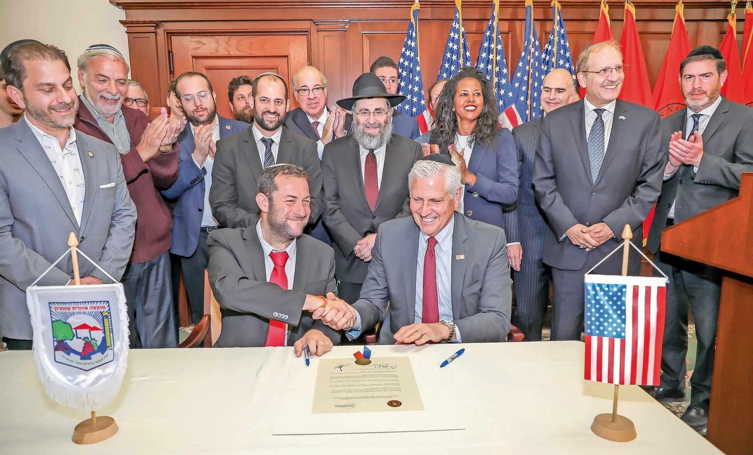 It was all smiles and friendship for Shomron Regional Council chair Yossi Dagan and Nassau County Executive Bruce Blakeman after signing an economic and cultural agreement between the two ‘sister’ regions. Joining them were, at far left, Assemblyman Ari Brown, and former Boro Park Assemblyman Dov Hikind, Rabbi Anchelle Perl of Chabad of Mineola, and County Legislator Mazi Melesa Pilip.