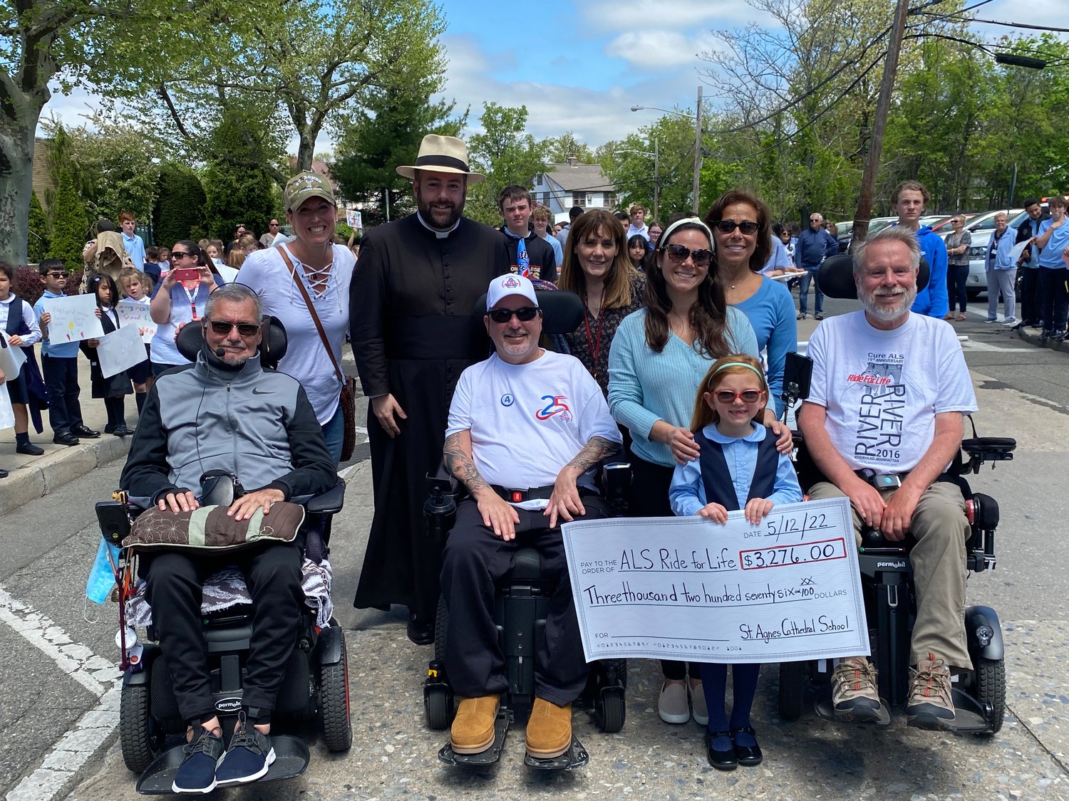 St. Agnes representatives presented the ALS Ride for Life with a check. Accepting were, from left, John Michael, Colleen Whaley, the Rev. Michael Duffy, Joe Cullum, Cecilia St. John, Alana Rollandie, her daughter, Addison Giarrizzo, Toni Lee Rollandie and Paul Weisman.