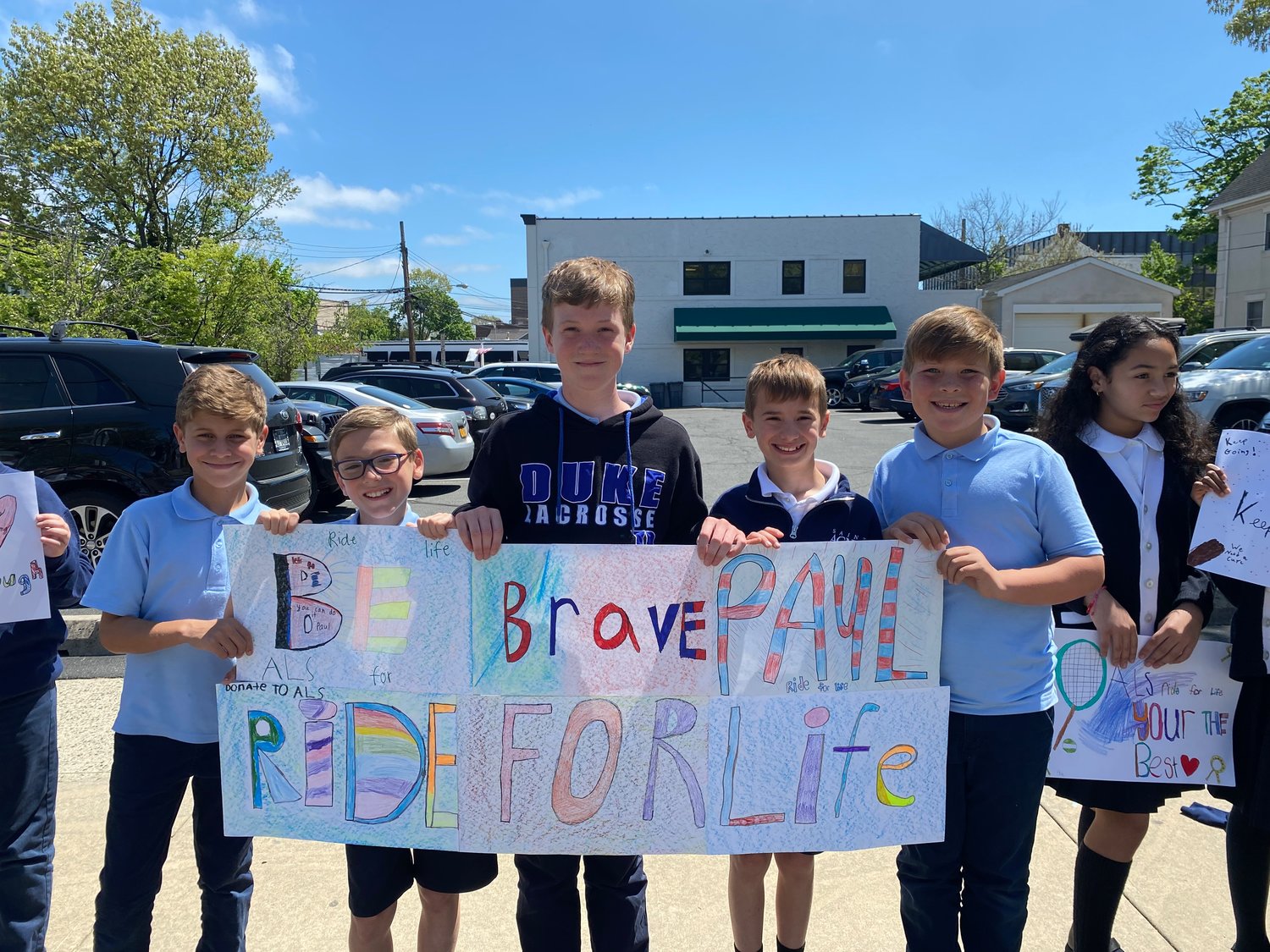 Students Philip, left, Salvatore, Kevin, Jack and John showed the banner they made in support of Paul Weisman and his fight against ALS.
