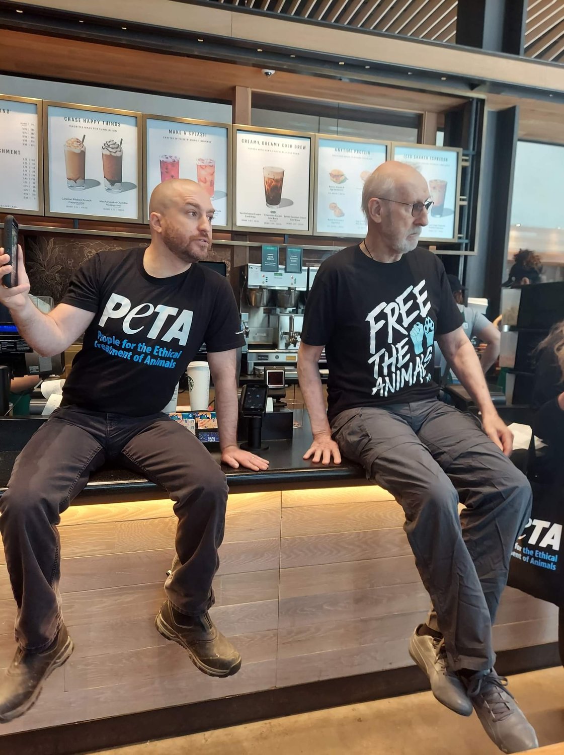 John Di Leonardo, left, president of Long Island Orchestrating for Nature, or LION, joined actor James Cromwell in a protest against Starbucks’ upcharge on vegan milk.