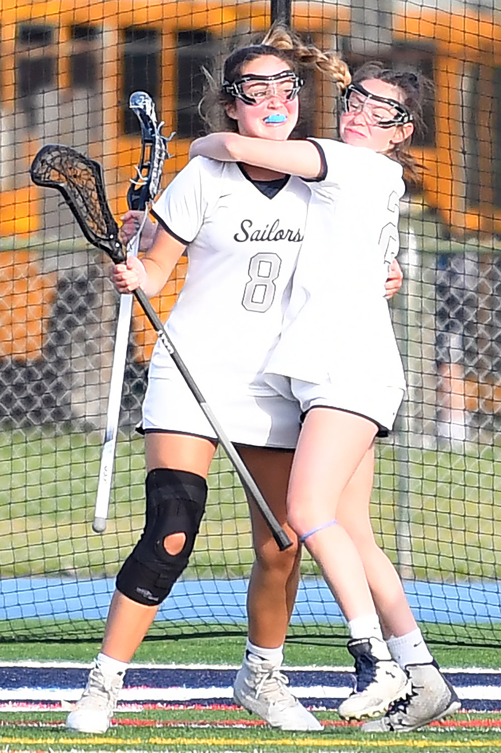 Oceanside’s Megan Checola, left, and Cassidy Reicherter celebrated after one of Checola’s five goals in the May 18 playoff win over East Meadow.